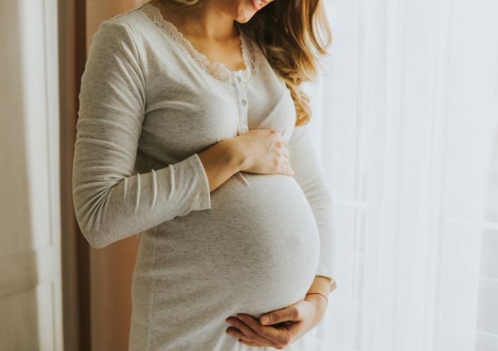 Pregnant woman holding her belly